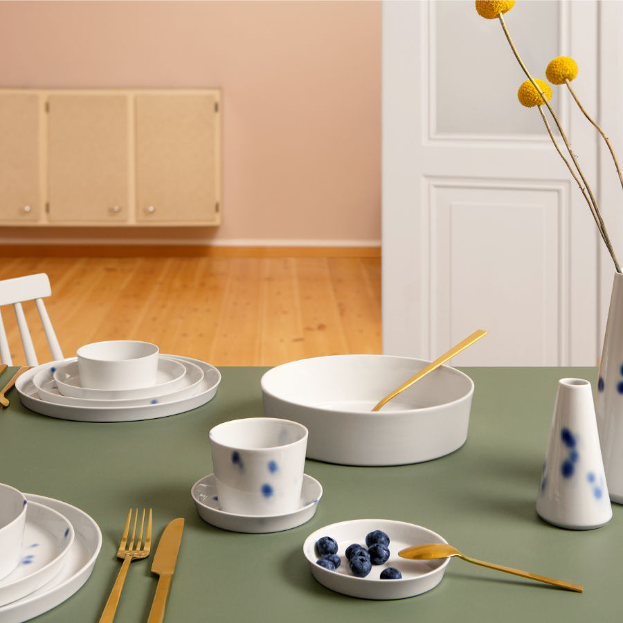 Porzellanschalen Porzellanbecher, Porzellan, teller, Porzellanvasen arrangiert auf einem Tisch mit blauem Dekor.