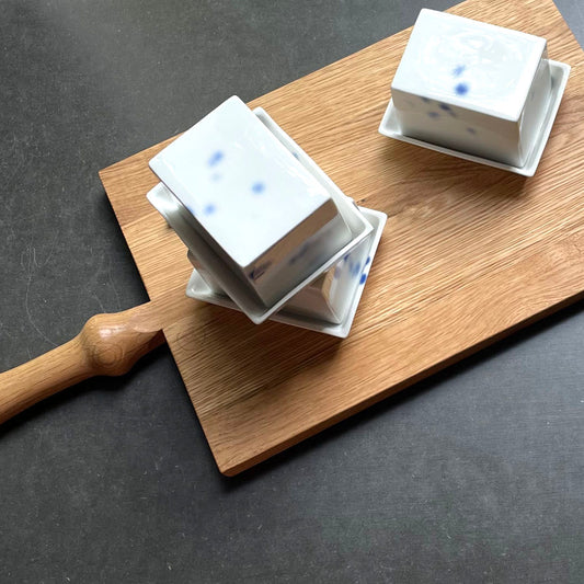 Kleine Butterdose aus Porzellan mit kobald blauen Tupfen auf Holzbrett
